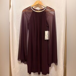 Womens cocktail dress.  Sleeveless sheath covered by a sheer cape.  Back zip.